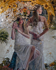 two women in white dresses painting